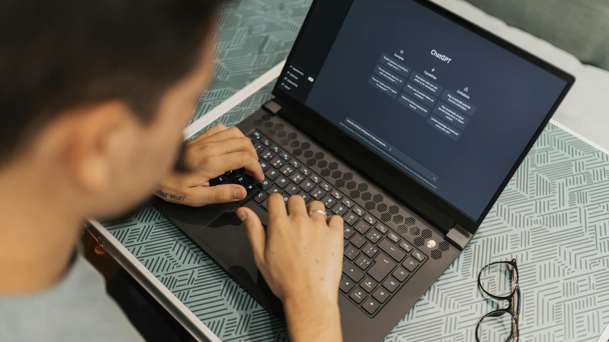 A person using an AI chatbot on a laptop for creative work