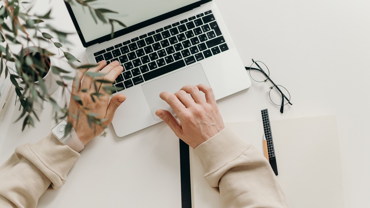 A person working on creative writing at a laptop, representing AI-assisted fiction workflows