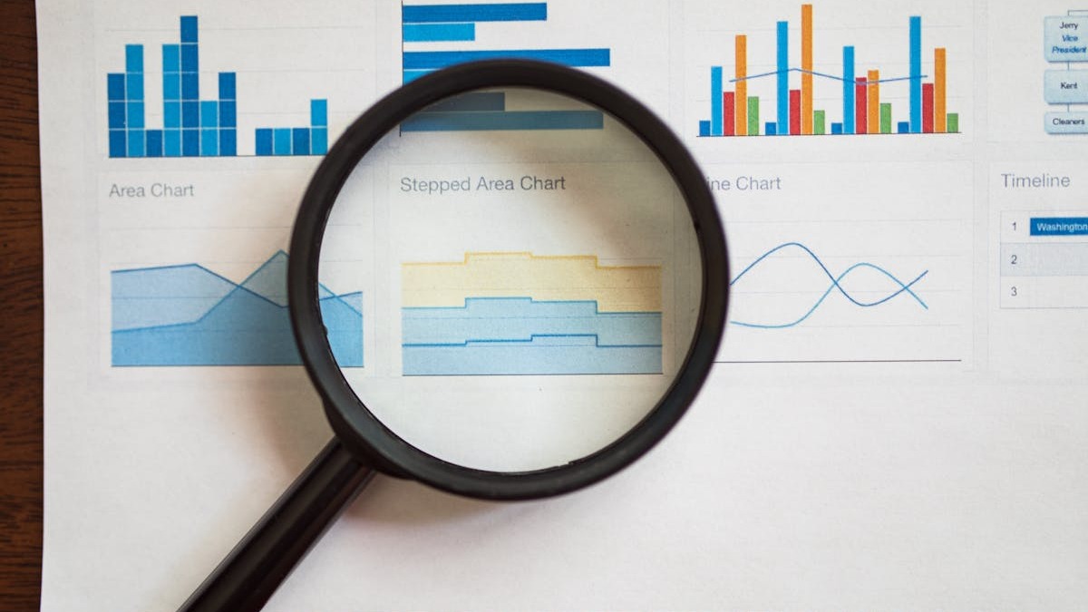 Charts and financial data analysis on printed paper with graphs
