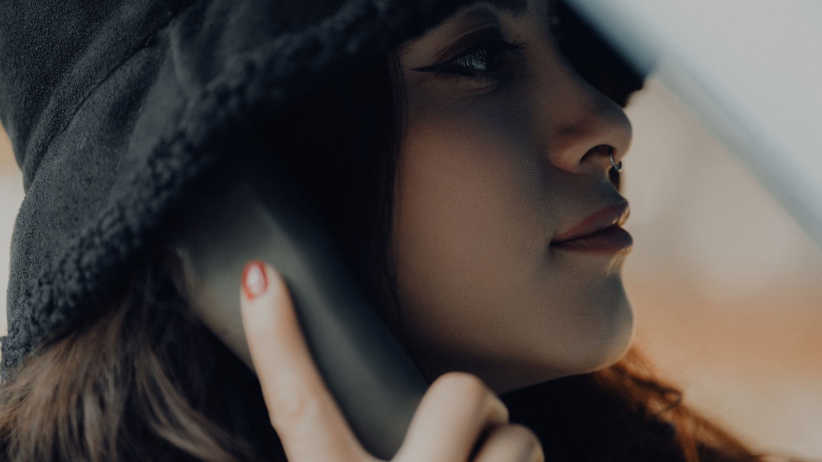 Close-up of a woman holding a smartphone to her ear during a phone call