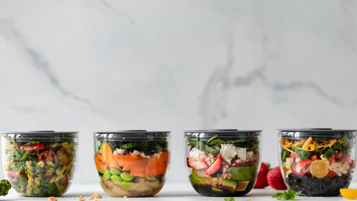 Colorful meal prep bowls with vegetables and protein arranged neatly