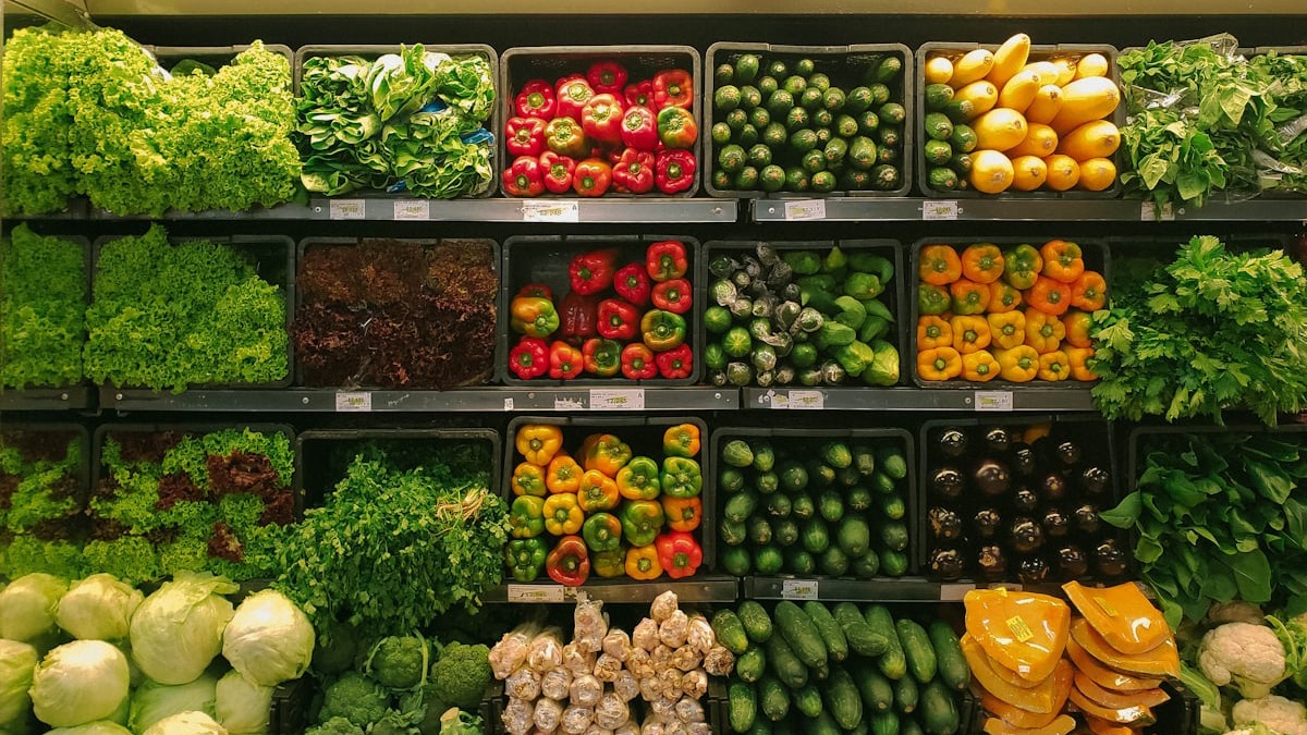 Fresh vegetables including broccoli, tomatoes, and herbs bundled together