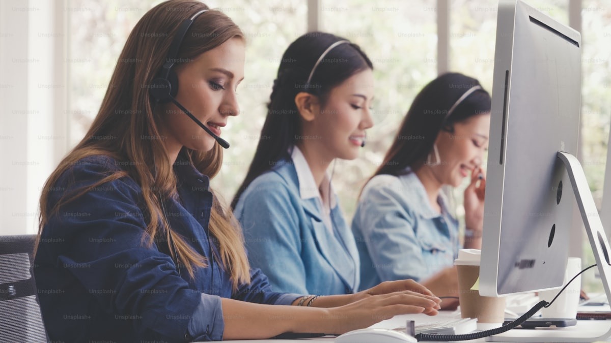 A headset and customer support equipment on a call center desk