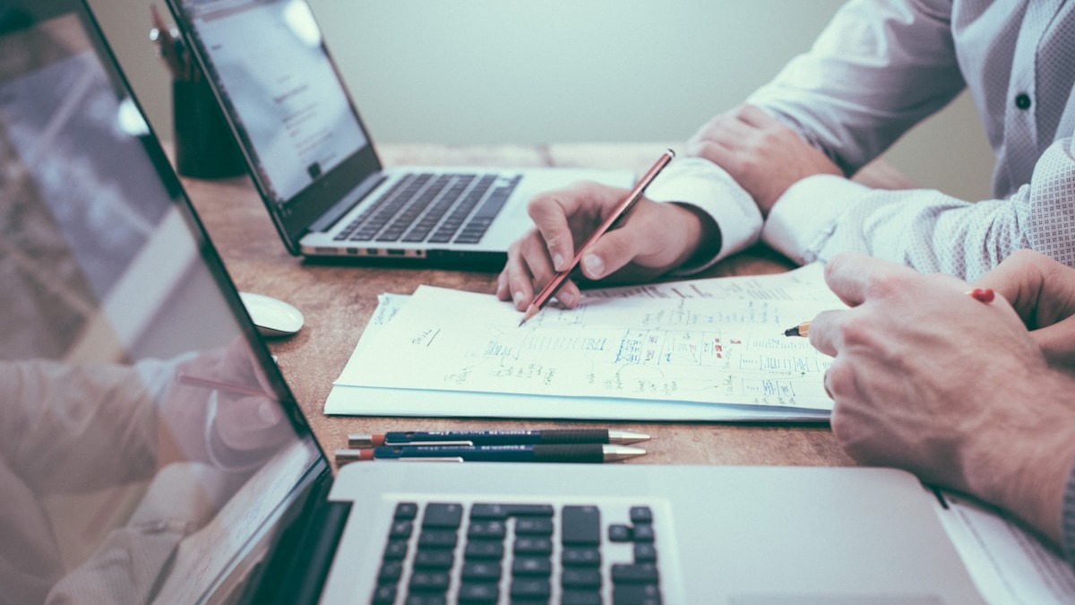 Person reviewing a resume document at a desk