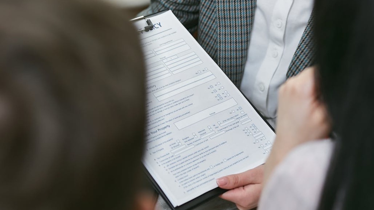 A person carefully reading a contract document before signing