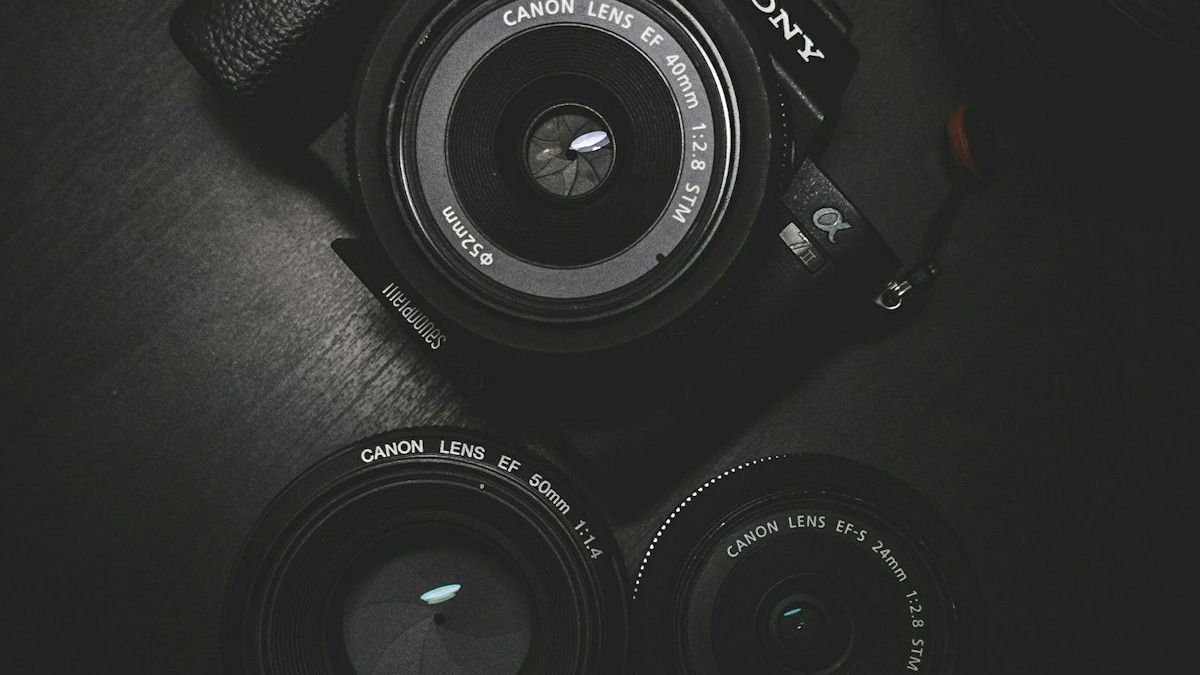 A camera and photography equipment on a wooden table