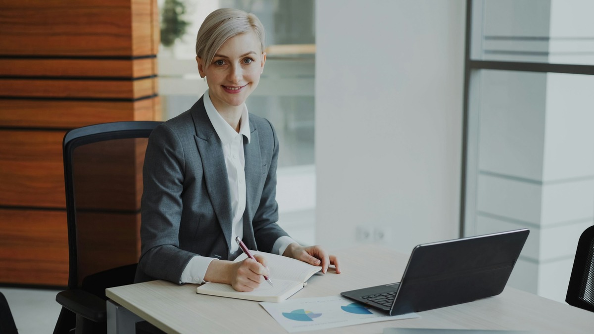 A professional preparing for a video interview at a desk