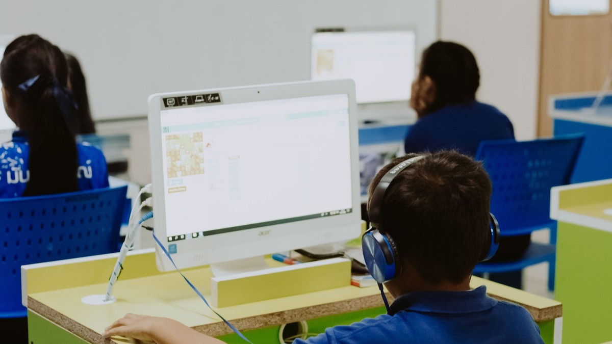 Students working on laptops in a modern classroom setting