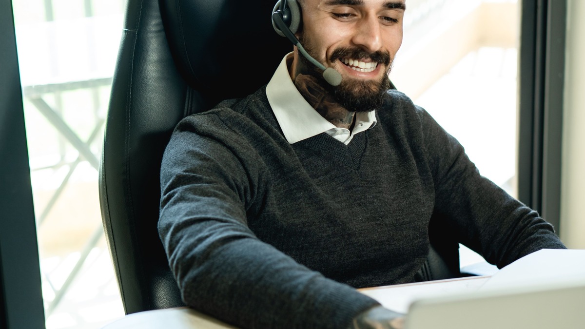 A customer service representative wearing a headset at a desk