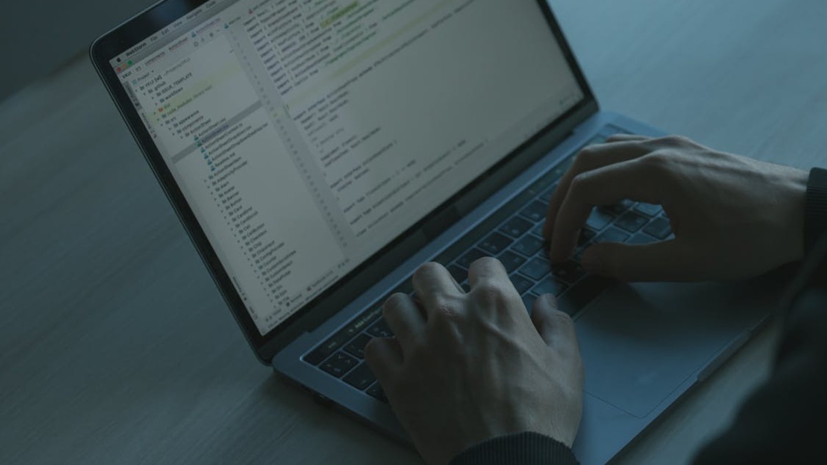 Developer working at a dual-monitor coding setup
