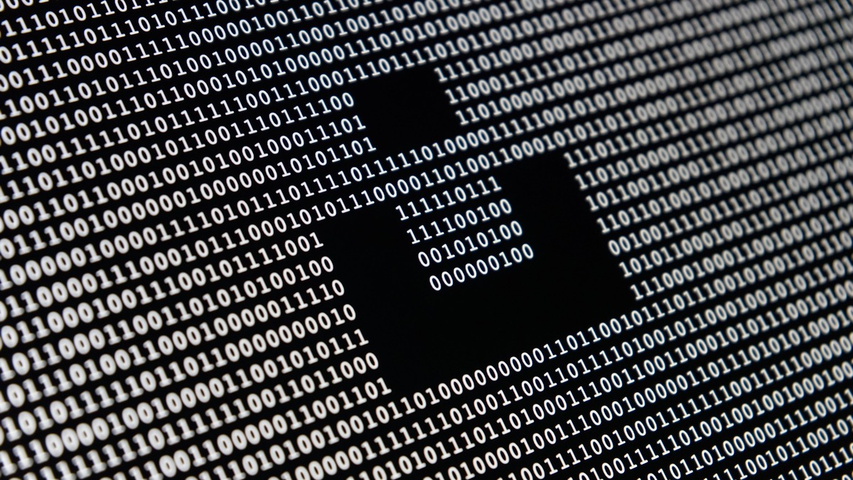 Binary code fills the screen with a padlock silhouette in the center