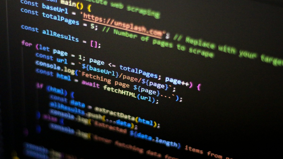 Close-up of colorful code on a dark computer screen