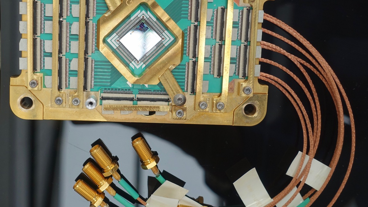 A superconducting quantum processor chip with transmon qubits wire-bonded to a circuit board