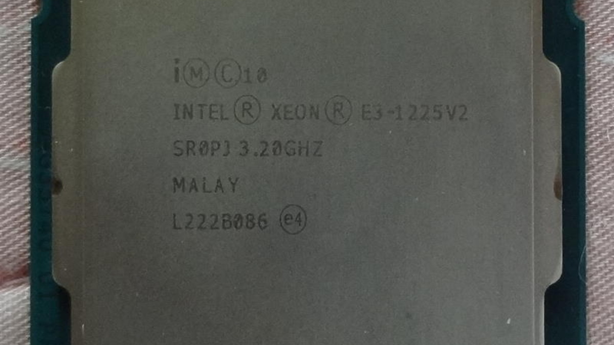 A macro photograph of an Intel Xeon E3-1225V2 processor, showing the printed model and speed markings