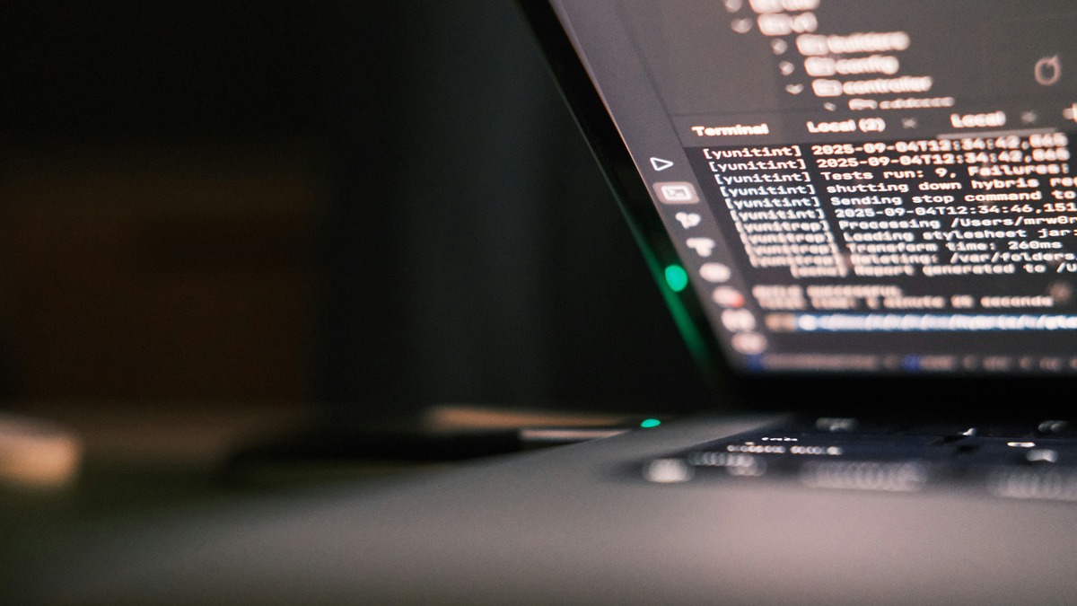Close-up of a laptop screen showing terminal output and test logs