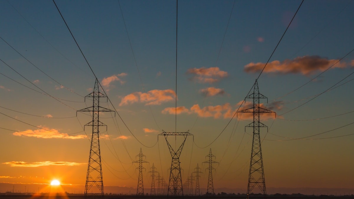 High-voltage power transmission lines against a clear sky