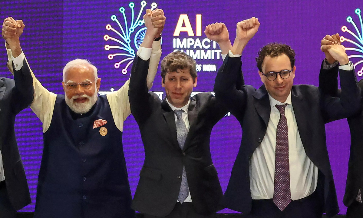 Sam Altman and Dario Amodei raise clenched fists instead of holding hands during a group photo with PM Modi at the India AI Impact Summit 2026