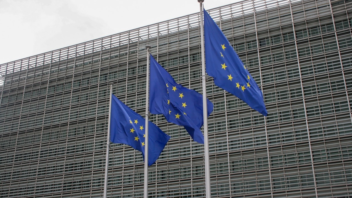 EU flags flying in front of the Berlaymont building in Brussels, European Commission headquarters