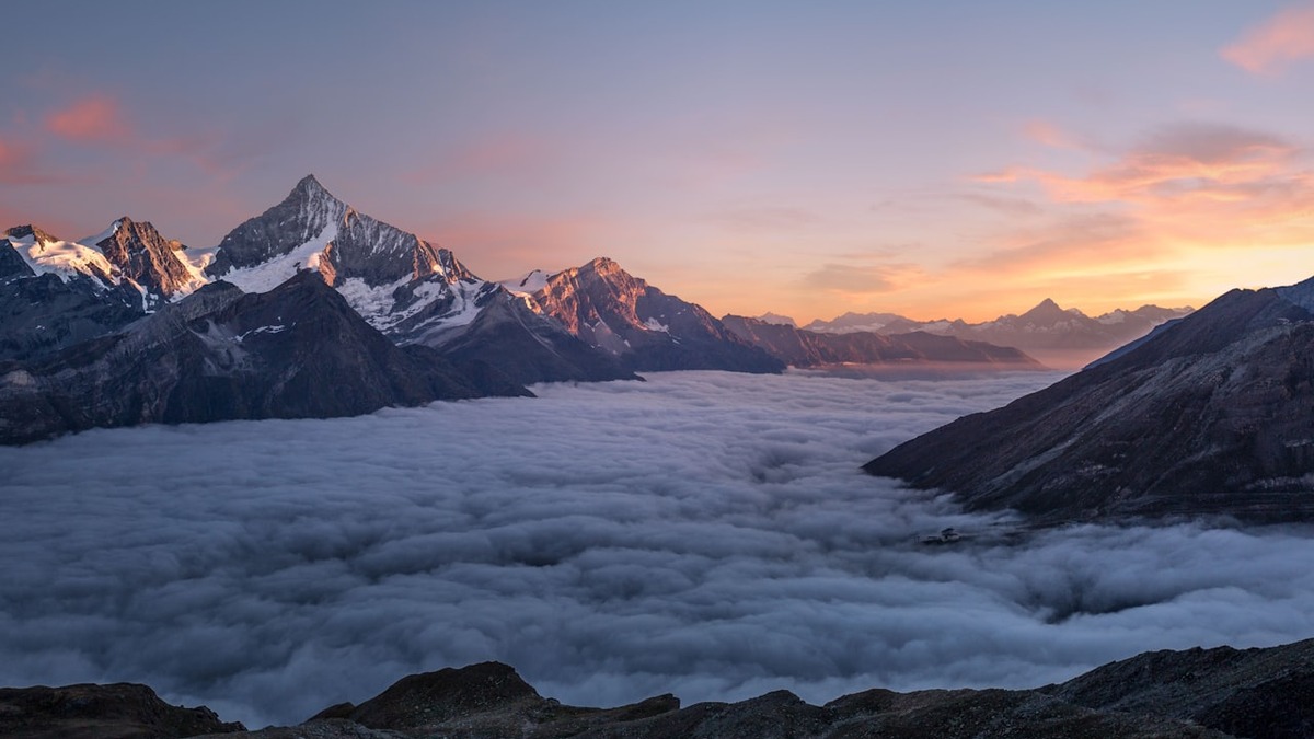 Alps mountains above clouds at sunset near Évian-les-Bains, France, where the G7 summit is being held June 15-17