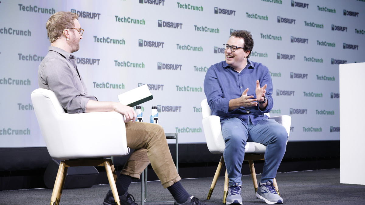 Dario Amodei speaking on stage during a TechCrunch Disrupt interview