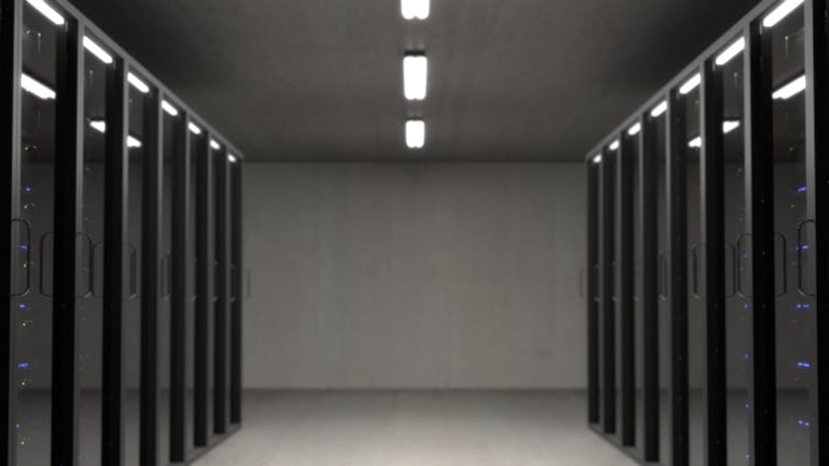 A data center server corridor stretching into the distance, illustrating the scale of compute infrastructure that major AI labs now require