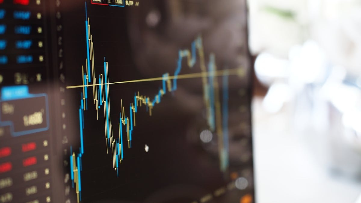 A financial trading screen showing market data and candlestick charts