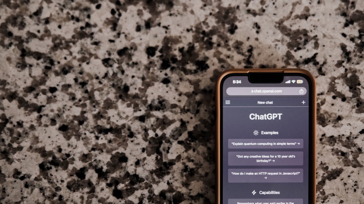 Close-up of smartphone displaying an AI chat interface on a textured surface