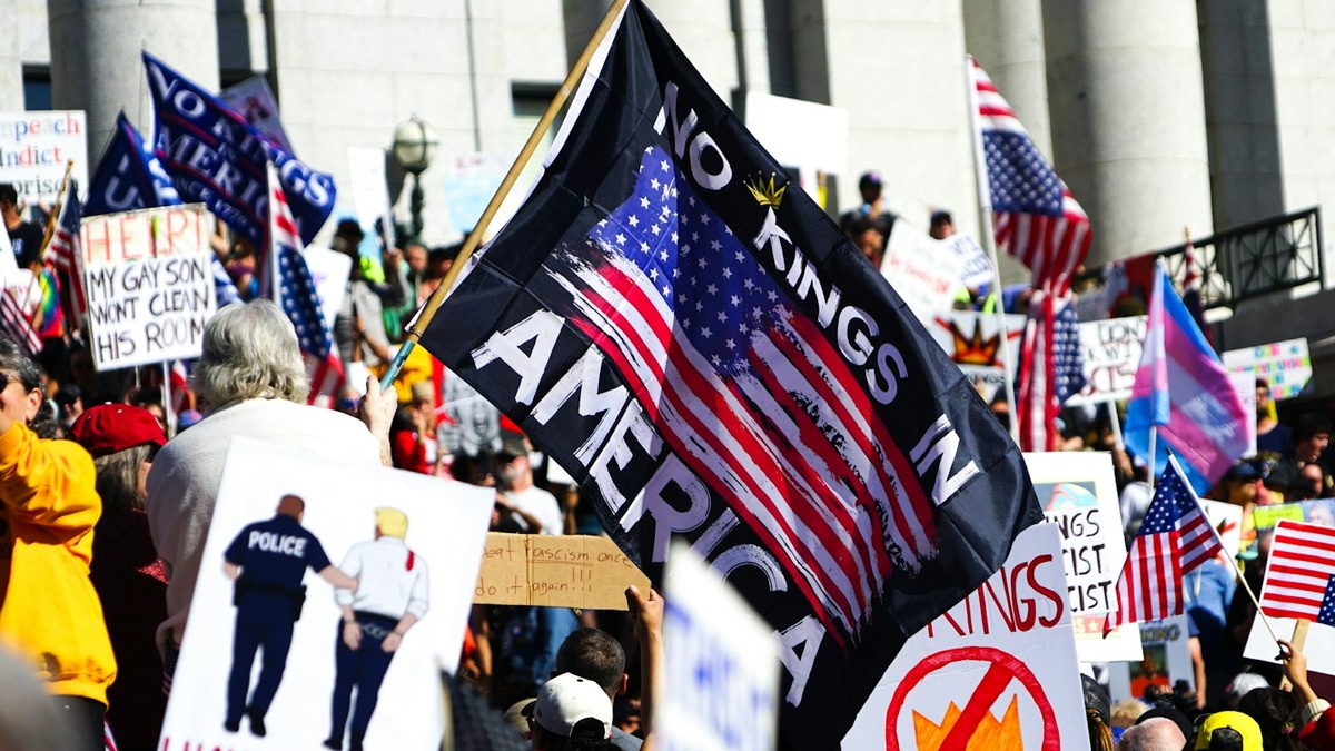 People protesting in the street holding signs and flags - the QuitGPT movement brought AI ethics into mainstream political discourse