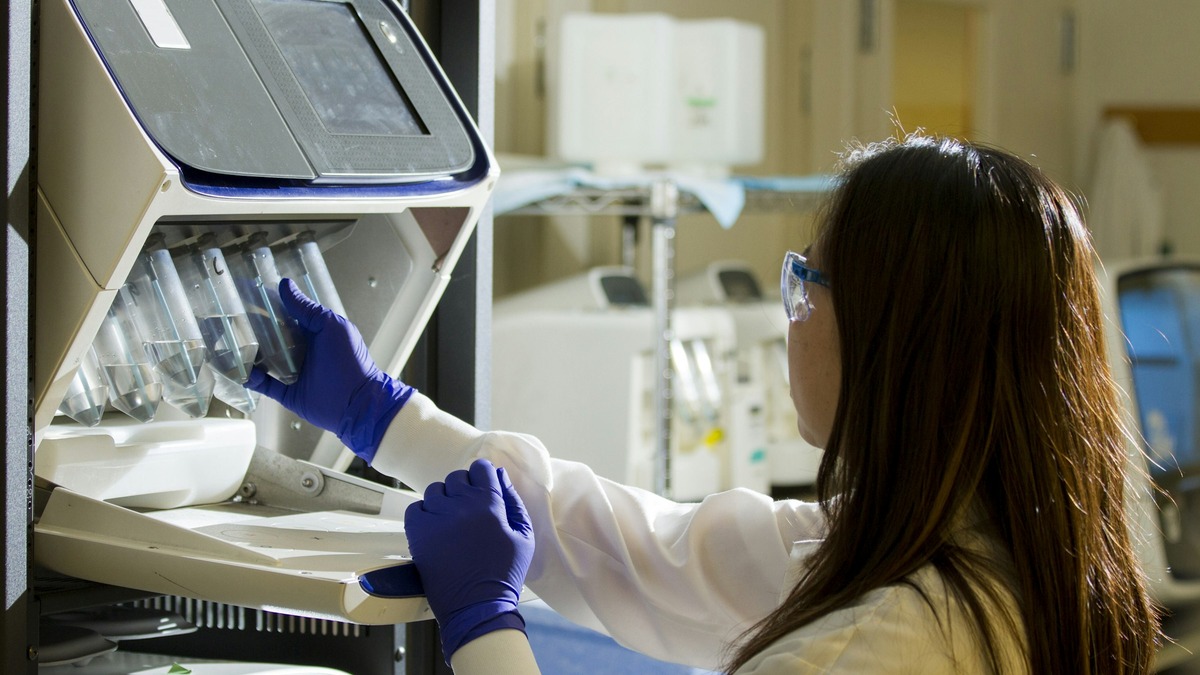 Technician holding test tubes in a sequencing lab