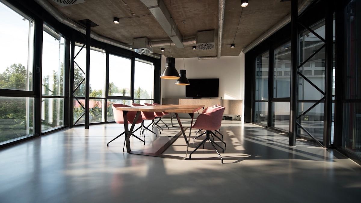 An empty corporate office space with desks and chairs