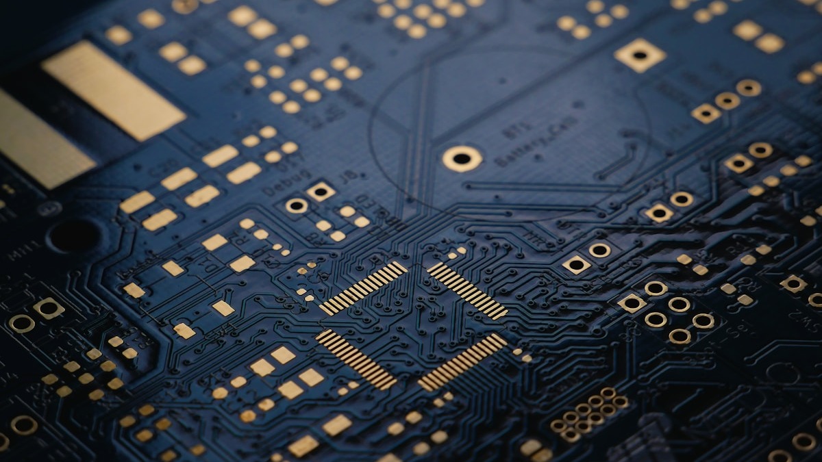 Dark blue circuit board close-up showing trace patterns and components