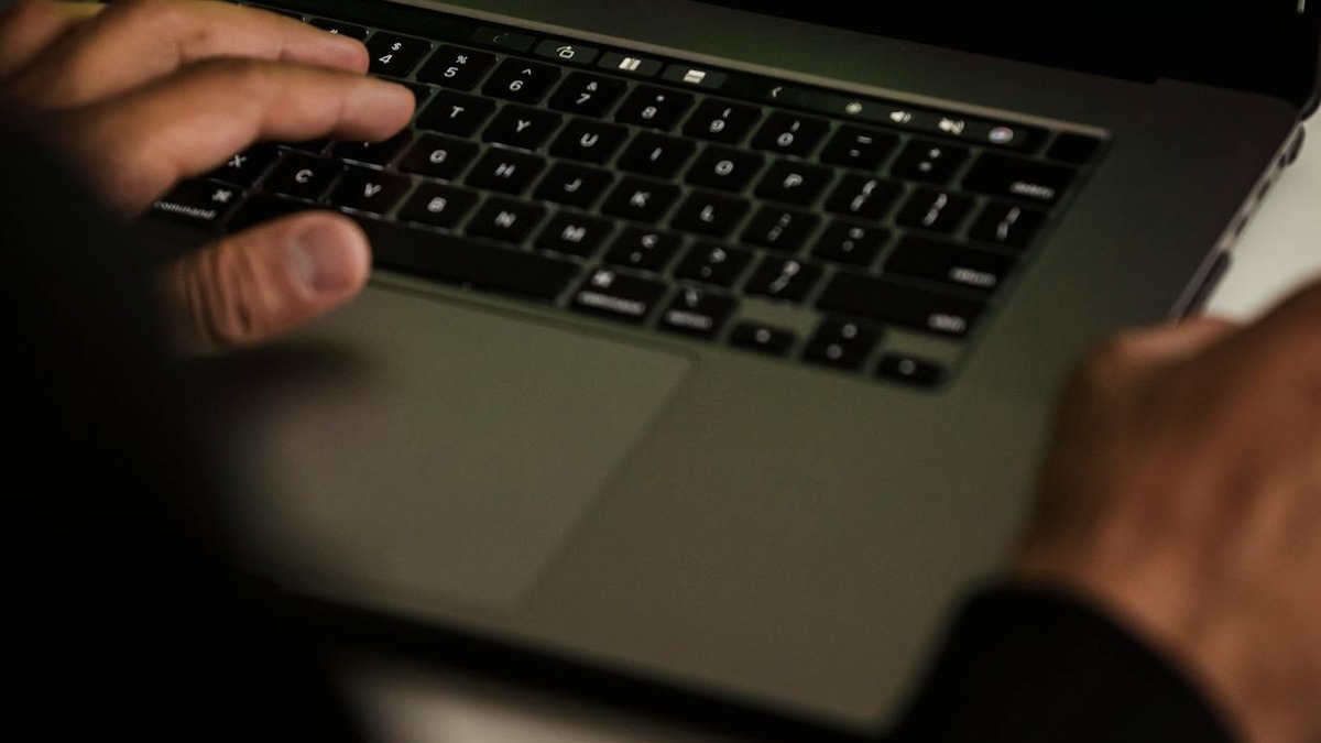 Close-up of a developer working at a terminal with code on screen