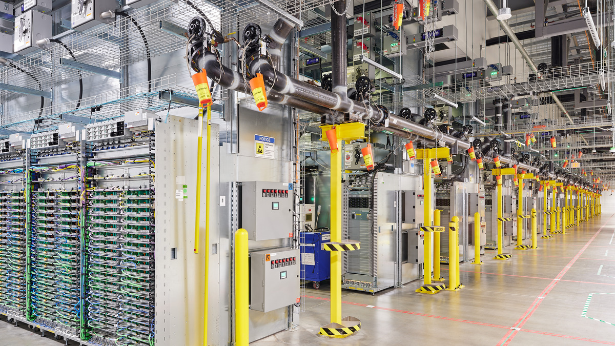 Rows of server racks and cooling infrastructure inside a Google data center