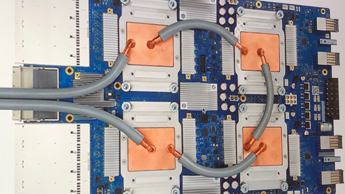 A Google TPU pod board with copper heat spreaders and liquid cooling tubes