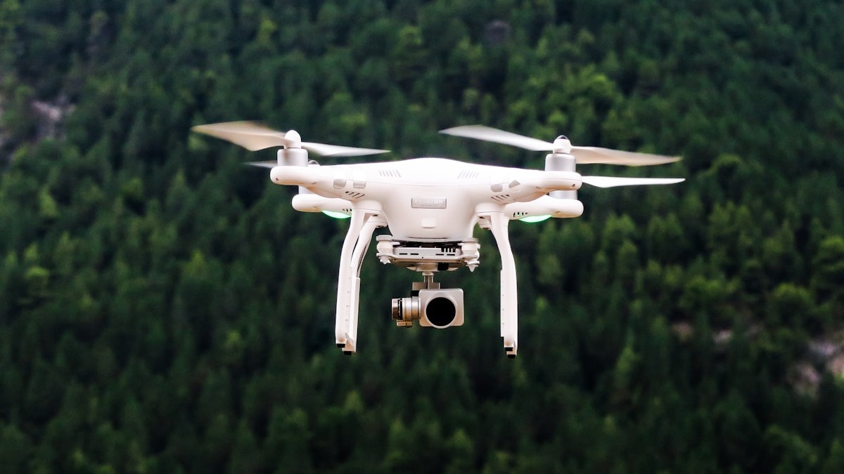A drone flying against a cloudy sky