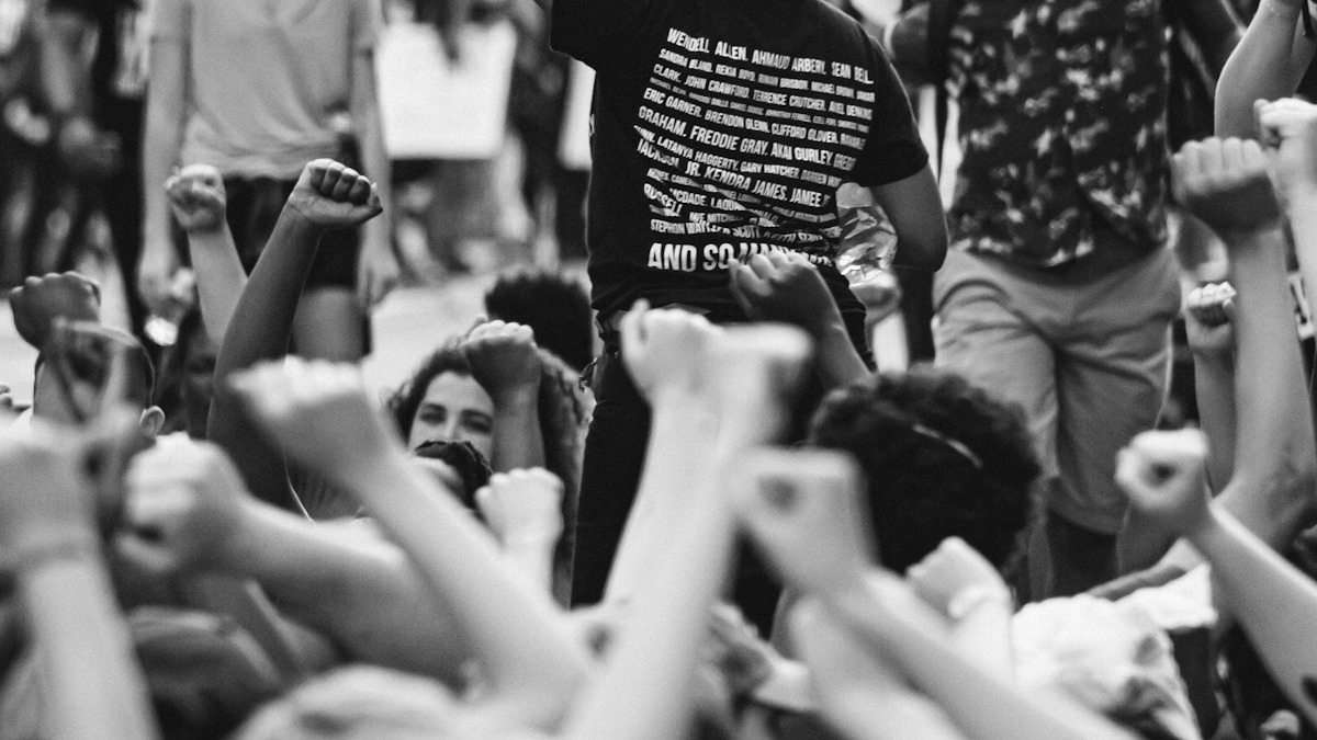 Protest sign being held up at a rally