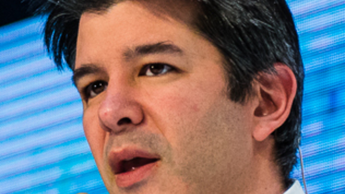 Travis Kalanick speaking on stage at a technology conference