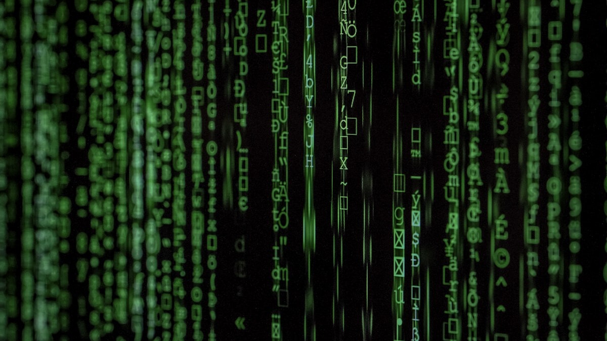 Binary code streaming down a dark terminal screen