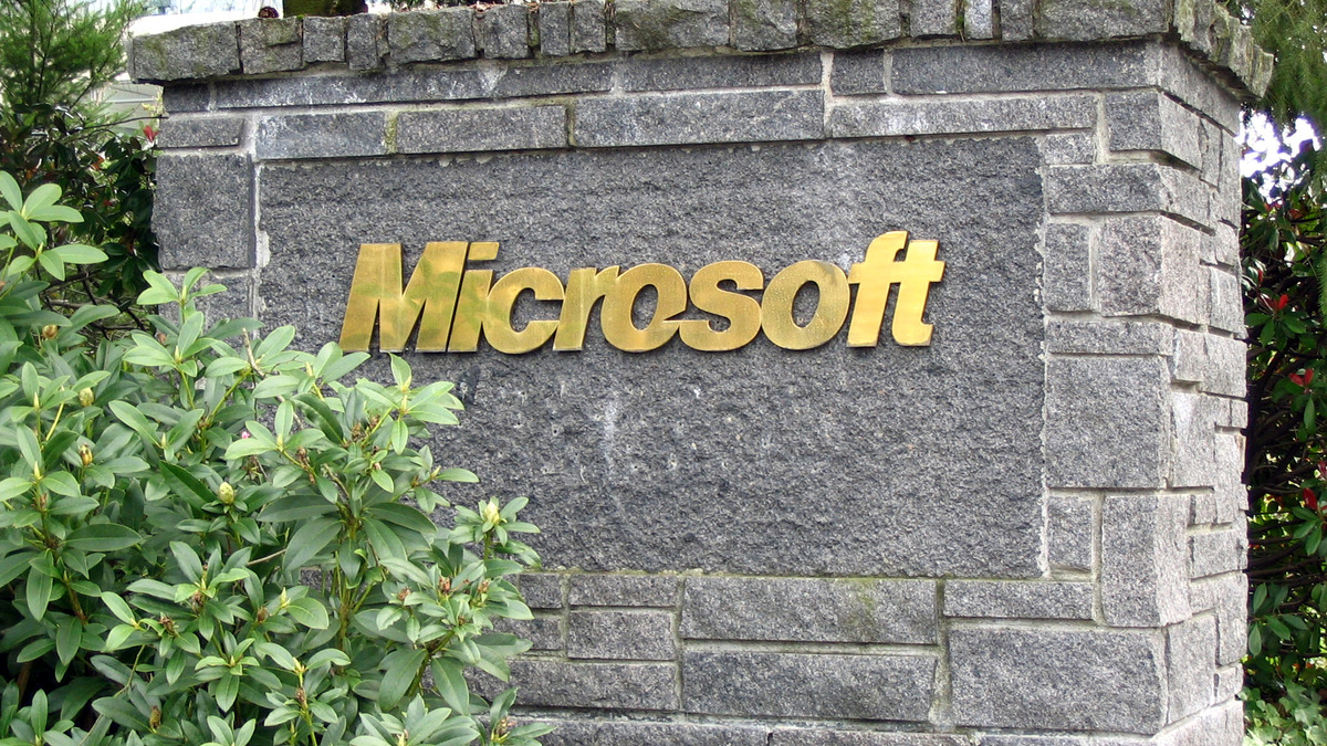 A granite Microsoft campus sign framed by greenery