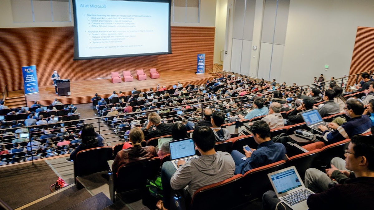 A machine learning conference audience during a technical session