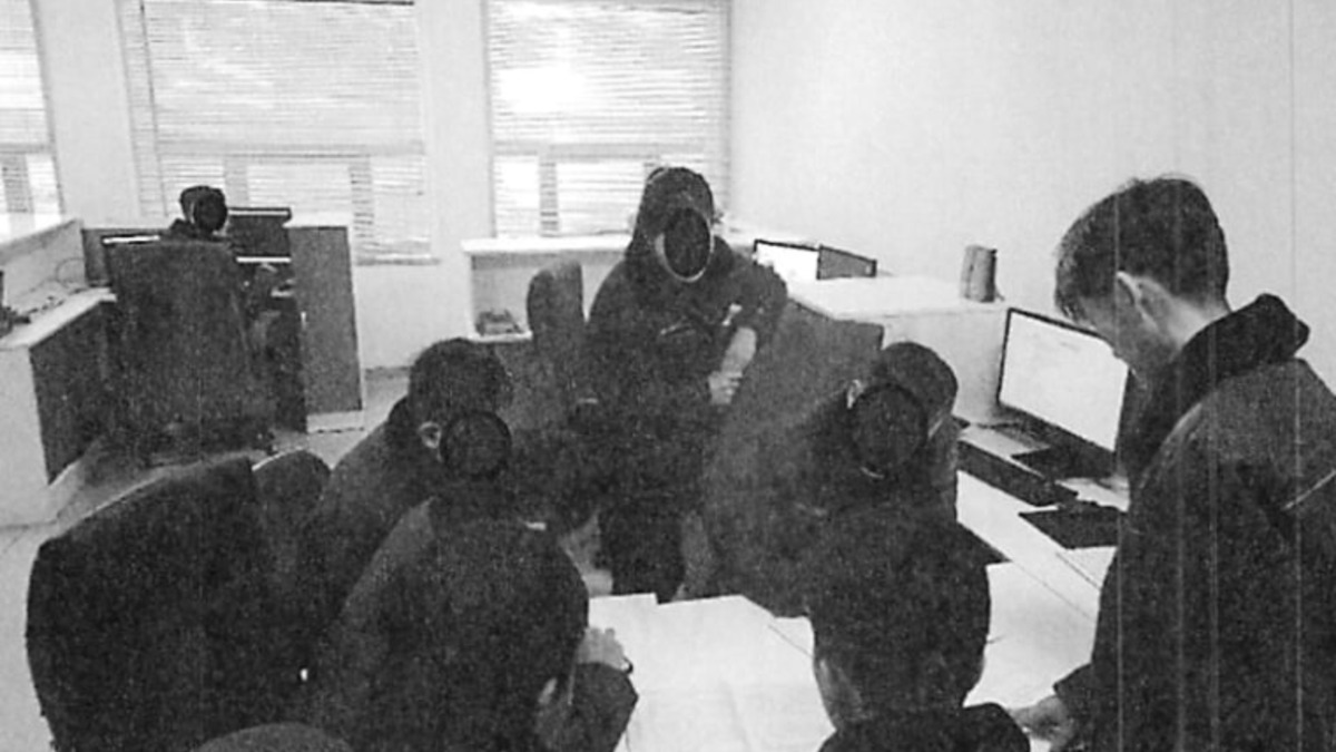North Korean IT workers at computers, photographed by US law enforcement