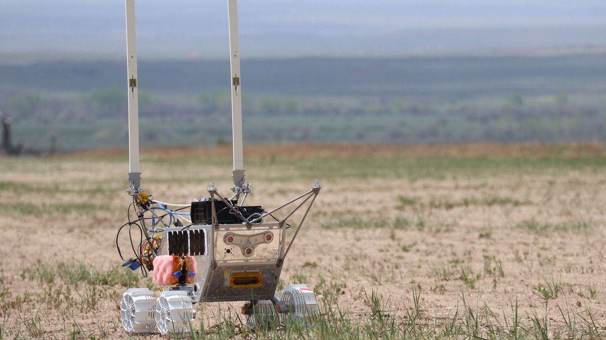 Lunar Outpost rover during a field test in a grassy Colorado landscape