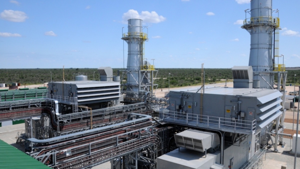 A natural gas turbine power plant with two exhaust stacks under a clear sky