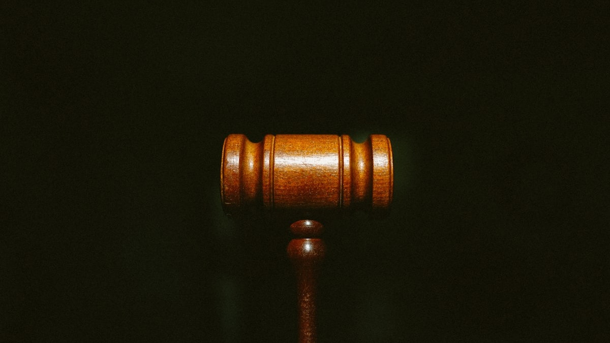 Legal scales and gavel on a wooden desk
