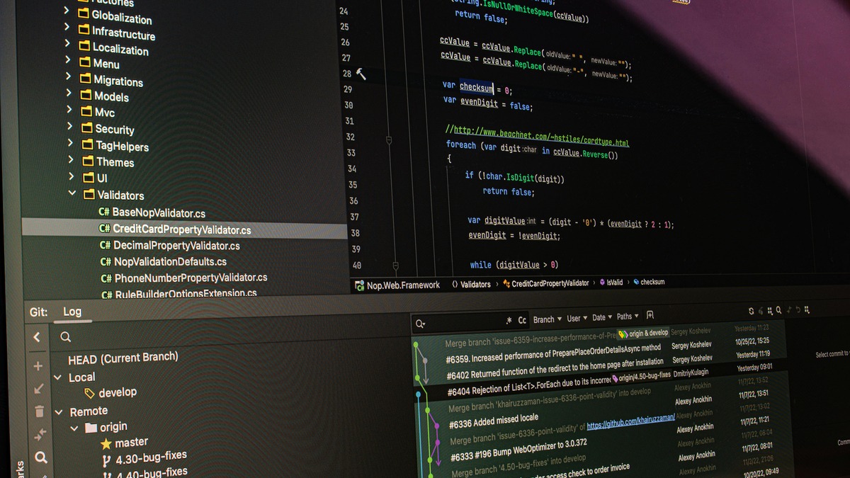 Developers working with multiple monitors showing code in an enterprise development environment