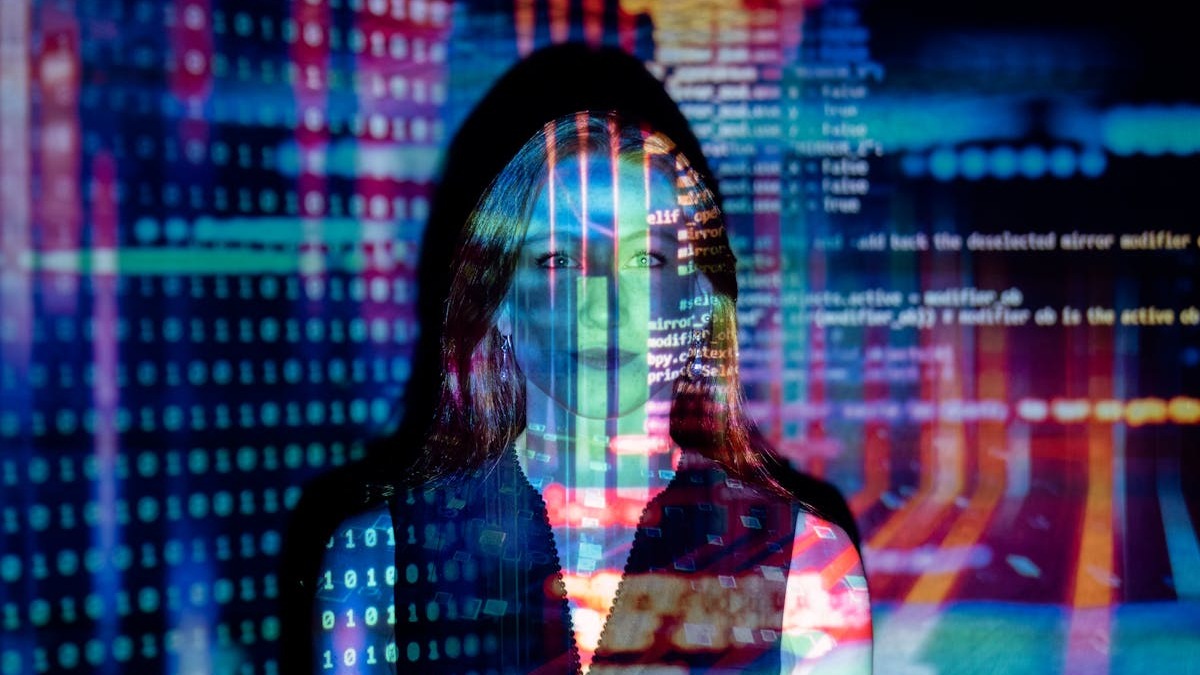 Code projection over a person's face representing AI data analysis