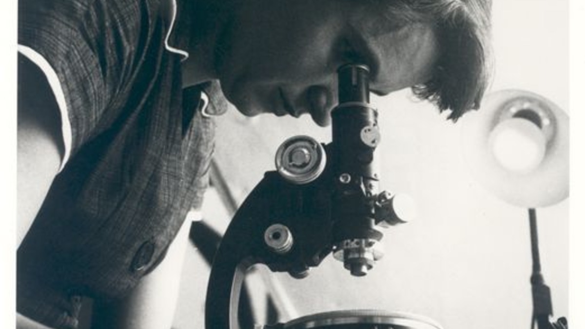 Rosalind Franklin in 1955, photographed with her microscope at Birkbeck College, London
