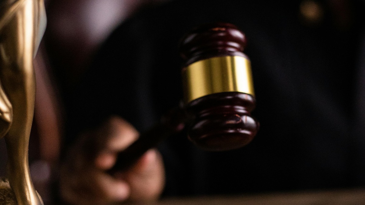 A judge's gavel, the symbol of legal accountability that SB 3444's critics say the bill would effectively neutralize for AI developers