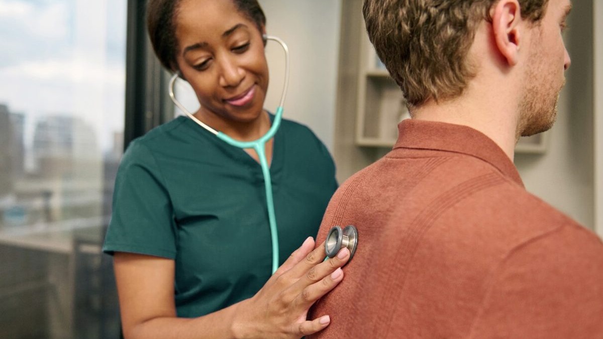 A doctor reviewing patient data on a screen alongside an AI diagnostic tool