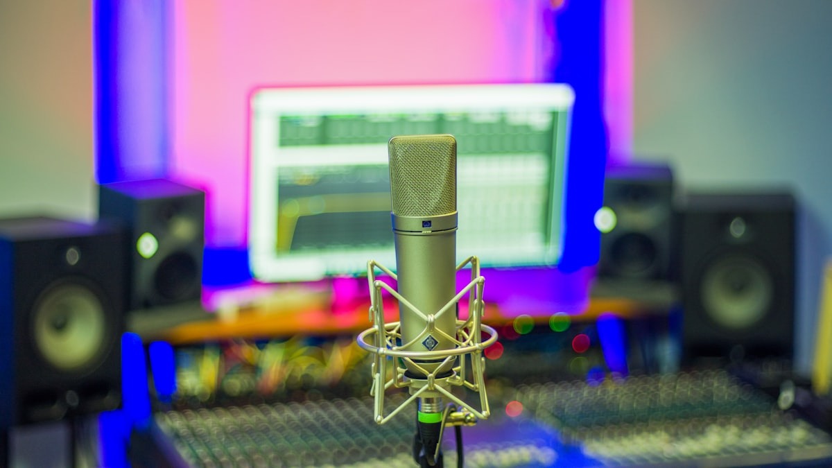 A microphone positioned for recording in front of a monitor